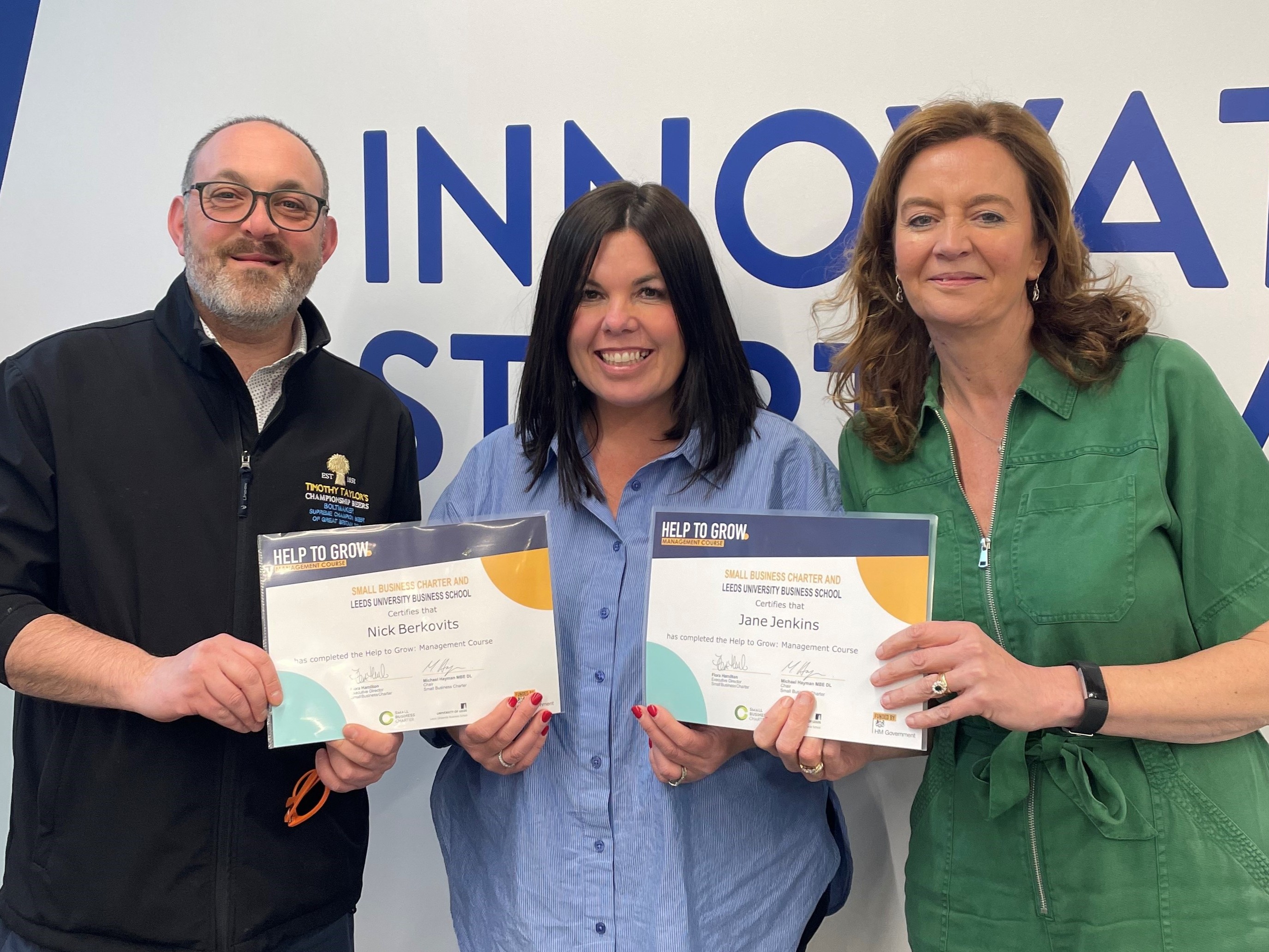 Timothy Taylor's team members receiving Help to Grow certificates.