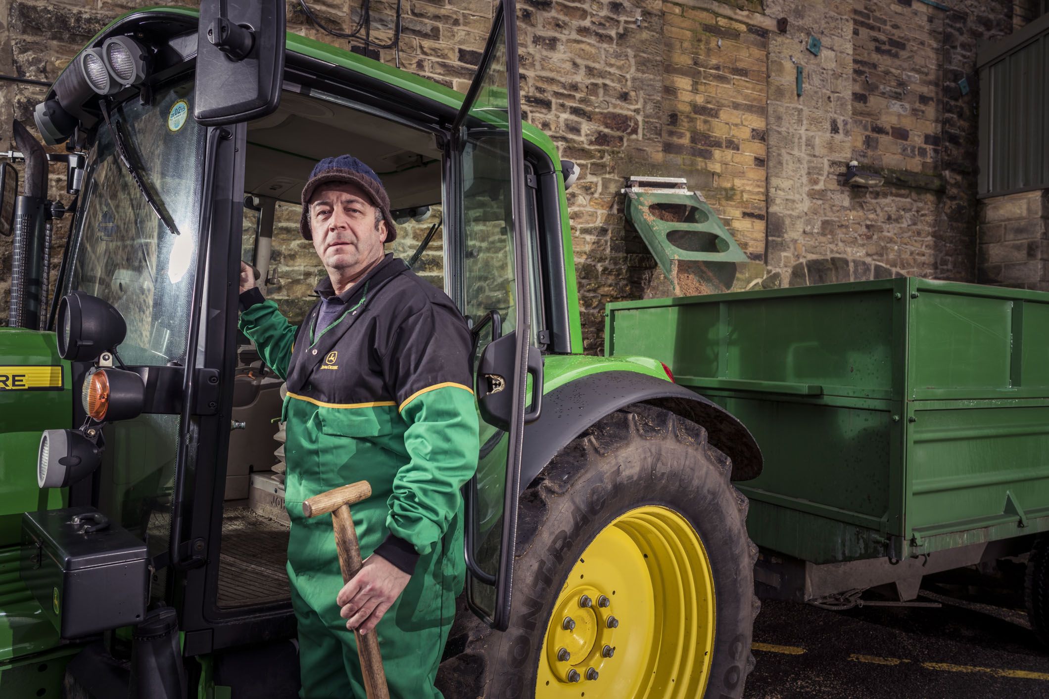 Farmer collecting spent grain from Timothy Taylor's brewery.